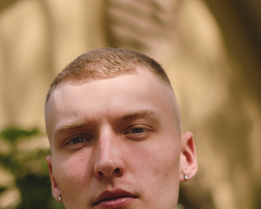 Portrait of a white British-looking man with a short even clipper cut